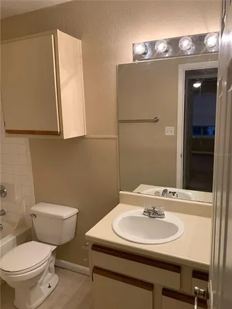 a bathroom with a sink toilet and mirror