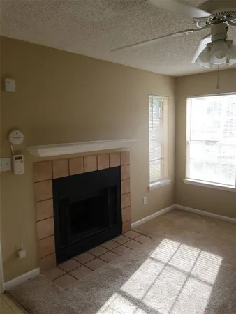 a living room with a fireplace and a window
