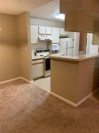a kitchen with stainless steel appliances a refrigerator and a stove top oven