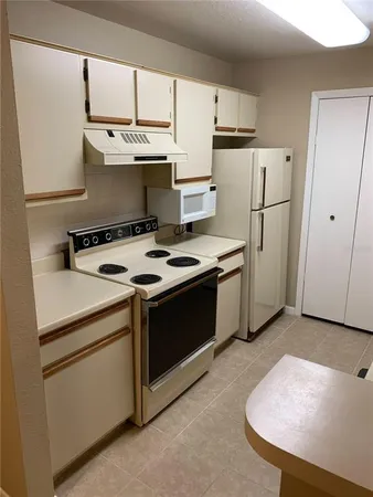 a stove top oven sitting inside of a kitchen