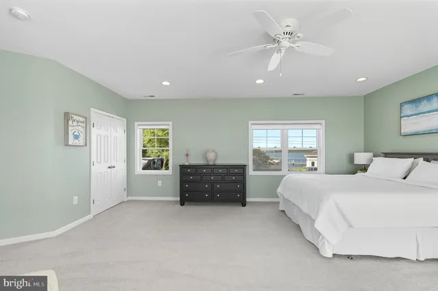 a spacious bedroom with a large bed and a couch