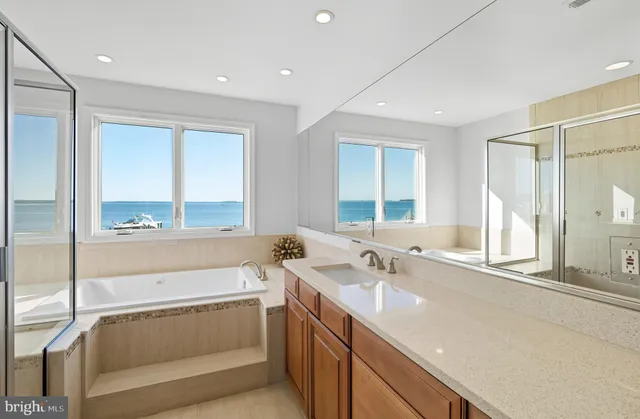 a spacious bedroom with a large bed and a chandelier