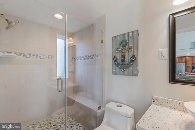 a bathroom with a toilet and a shower