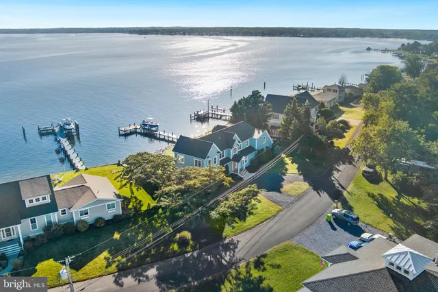 an aerial view of a house with outdoor space and a lake view