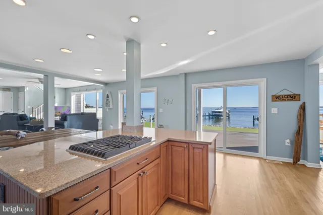 a kitchen with stainless steel appliances granite countertop a stove a refrigerator and a sink