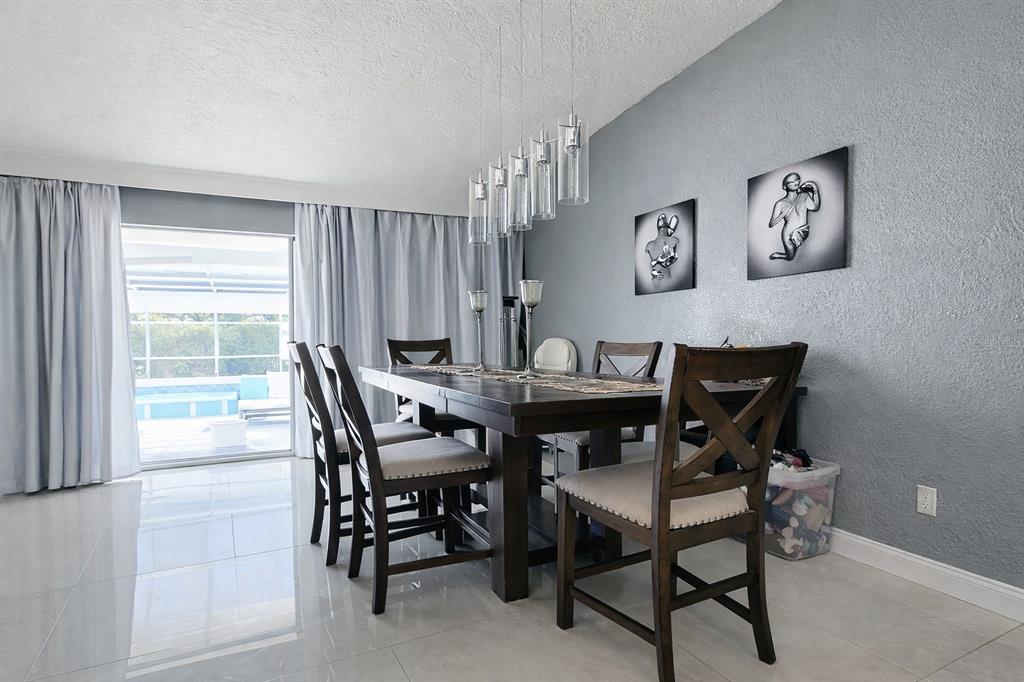 1840 Flametree Lane Venice, FL 34293 - Photo 12 of 26 a view of a dining room with furniture and a window