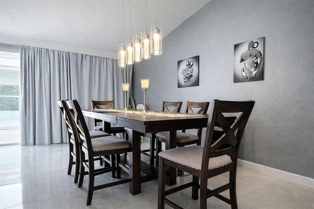 1840 Flametree Lane Venice, FL 34293 - Photo 13 of 26 a view of a dining room with furniture and chandelier