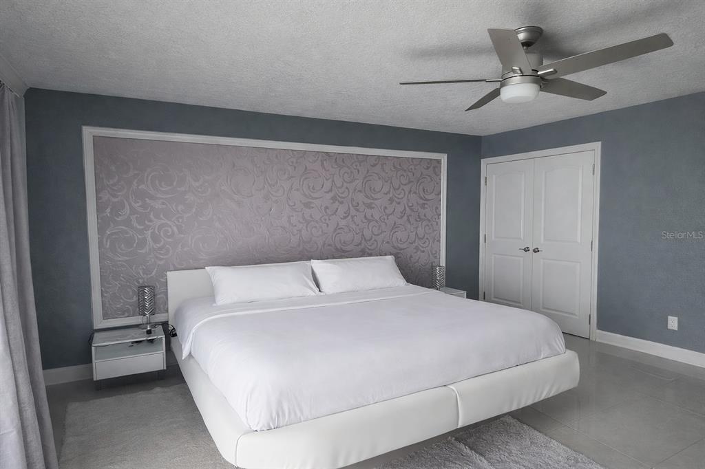 1840 Flametree Lane Venice, FL 34293 - Photo 15 of 26 a bedroom with a bed and a ceiling fan