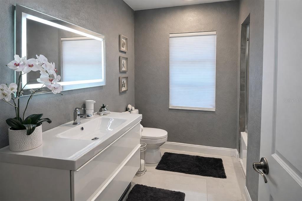 1840 Flametree Lane Venice, FL 34293 - Photo 18 of 26 a bathroom with a sink a toilet and a mirror