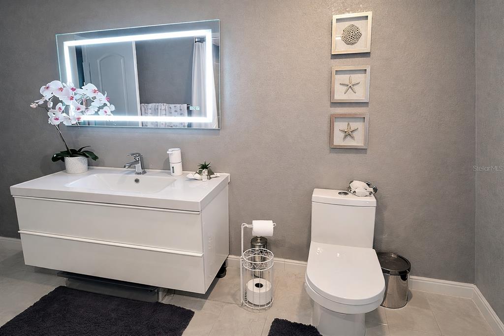 1840 Flametree Lane Venice, FL 34293 - Photo 19 of 26 a bathroom with a toilet sink and mirror