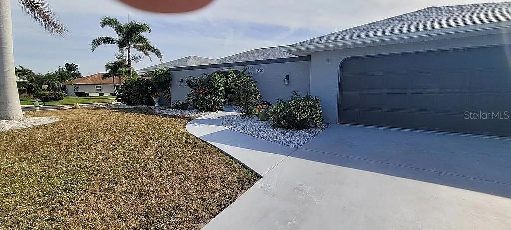 1840 Flametree Lane Venice, FL 34293 - Photo 3 of 26 a front view of a house with a yard