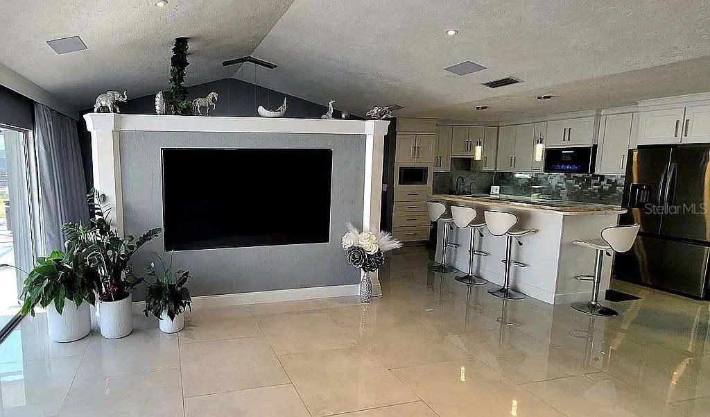 1840 Flametree Lane Venice, FL 34293 - Photo 10 of 26 a living room with furniture a fireplace and a potted plant
