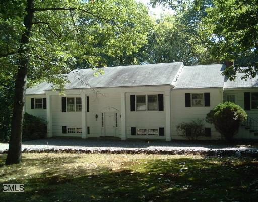 710 Rock Ridge Road Fairfield, CT 06824 - Photo 1 of 1 a view of a house with swimming pool and a yard