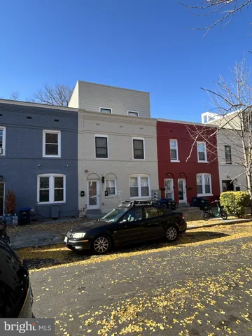 a front view of building with cars parked