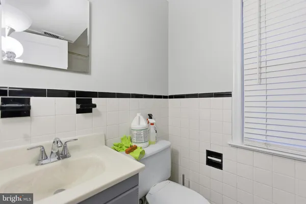 a bathroom with a sink mirror vanity and toilet