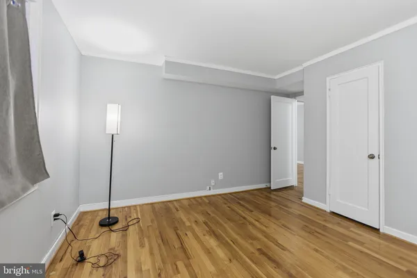 a view of a room with wooden floor