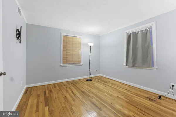 a view of an empty room with wooden floor
