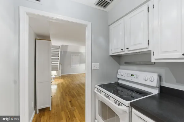 a kitchen with a stove and a cabinet
