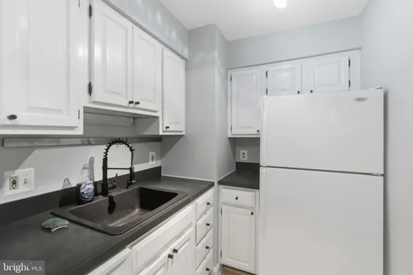 a kitchen with refrigerator a sink and cabinets