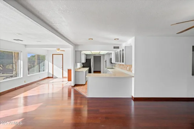 a view of living room with furniture and large windows