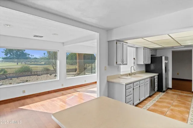 a large kitchen with a stove and a sink
