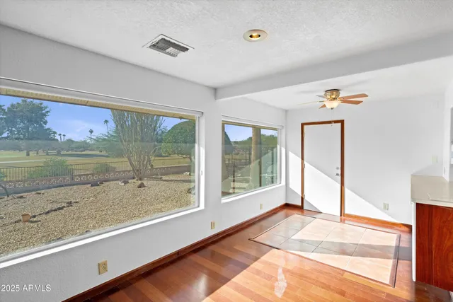 a view of a room with wooden floor and window