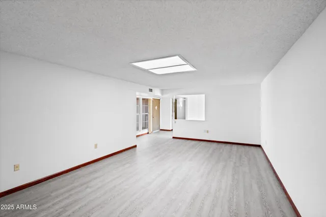 a view of a room with wooden floor and a window