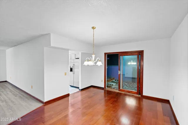 a view of a room with wooden floor and window