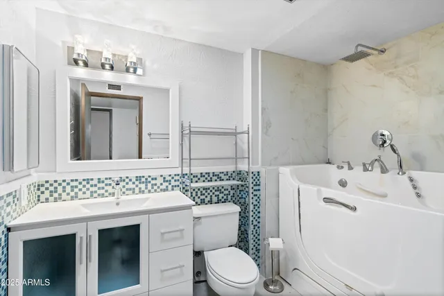 a bathroom with a sink a toilet and mirror