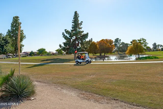 a view of a house with a deck and a yard