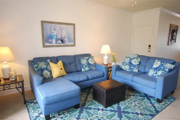 a living room with furniture and painting on the wall