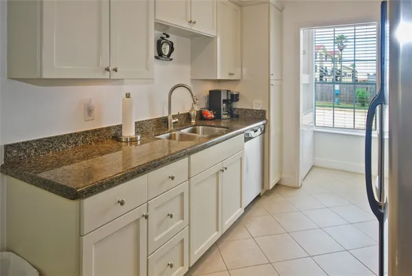 a kitchen with stainless steel appliances a refrigerator and a sink