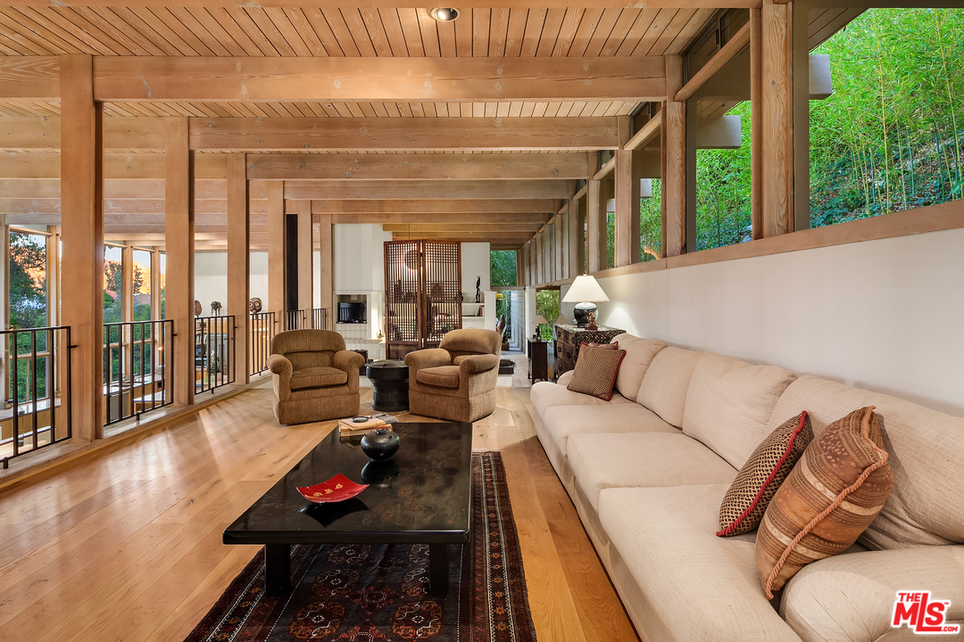 7330 Pyramid Drive Los Angeles, CA 90068 - Photo 14 of 37 a living room with furniture floor to ceiling window and wooden floor