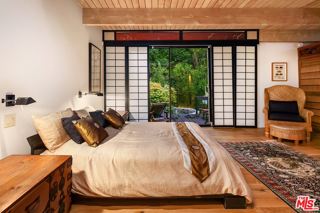 7330 Pyramid Drive Los Angeles, CA 90068 - Photo 24 of 37 a bed sitting in a bedroom next to a window