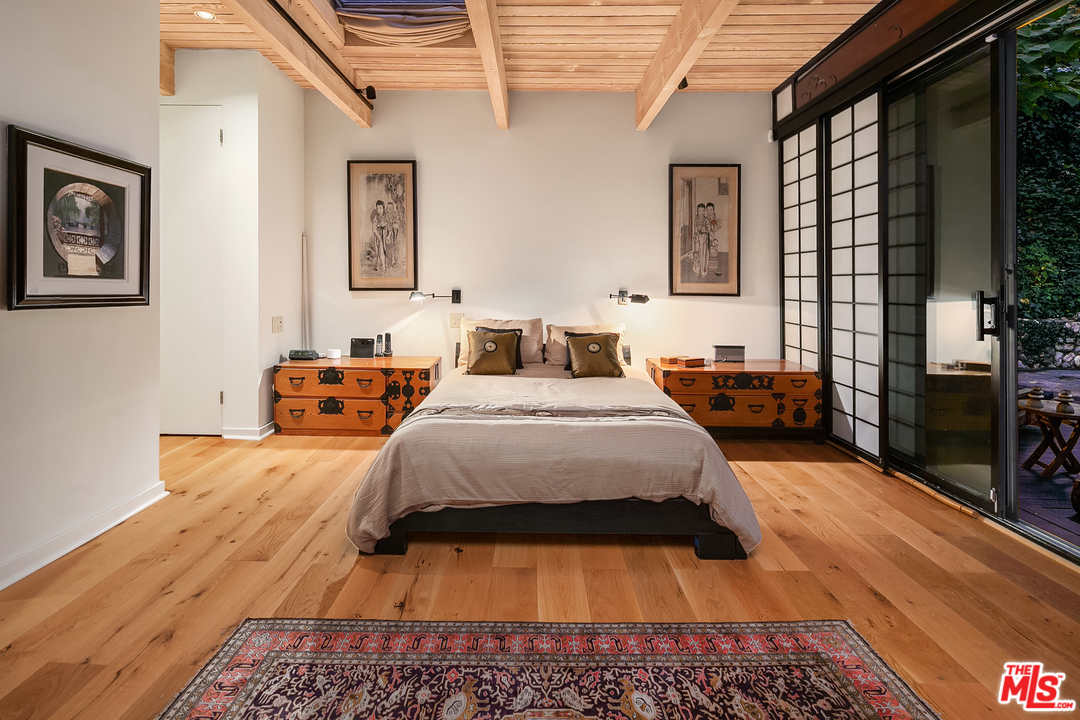 7330 Pyramid Drive Los Angeles, CA 90068 - Photo 27 of 37 a bed sitting in a bedroom next to a window