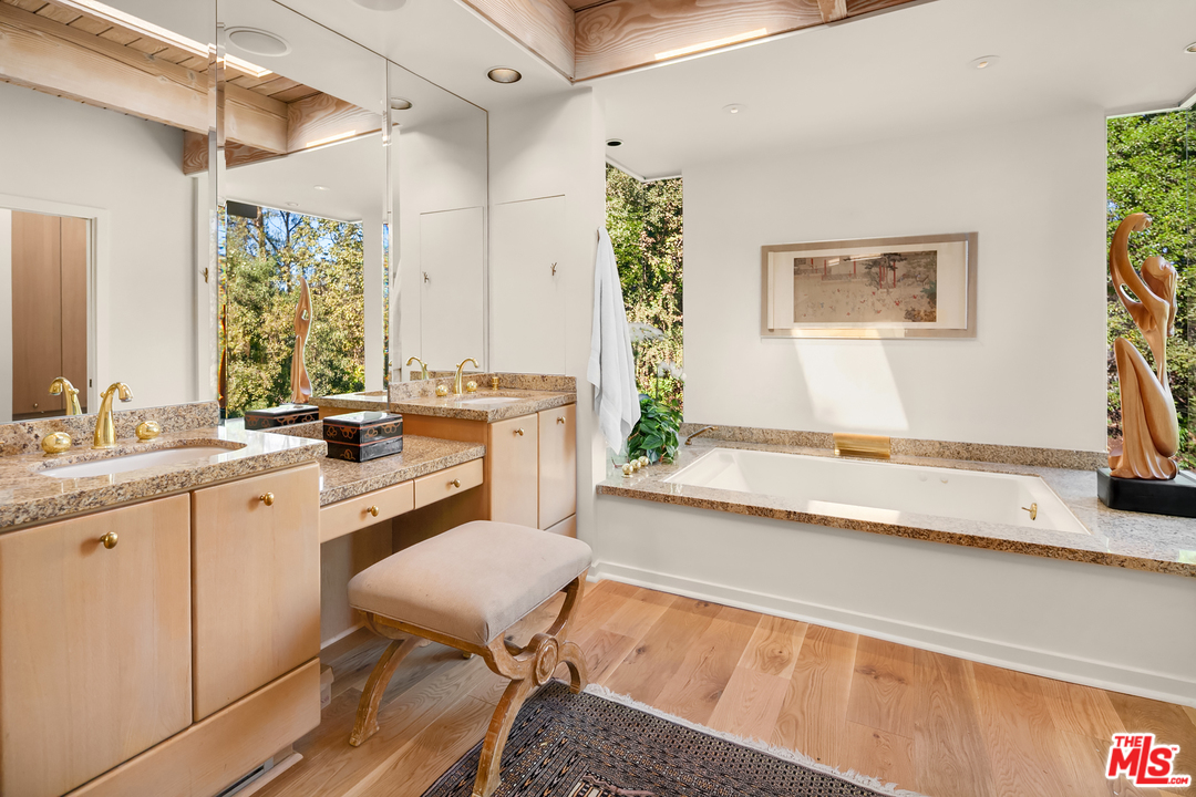 7330 Pyramid Drive Los Angeles, CA 90068 - Photo 28 of 37 a spacious bathroom with a sink a large mirror and a bathtub