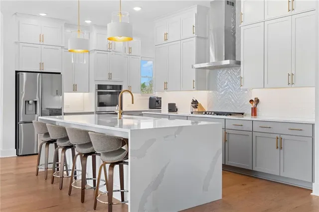 a kitchen with white cabinets and sink