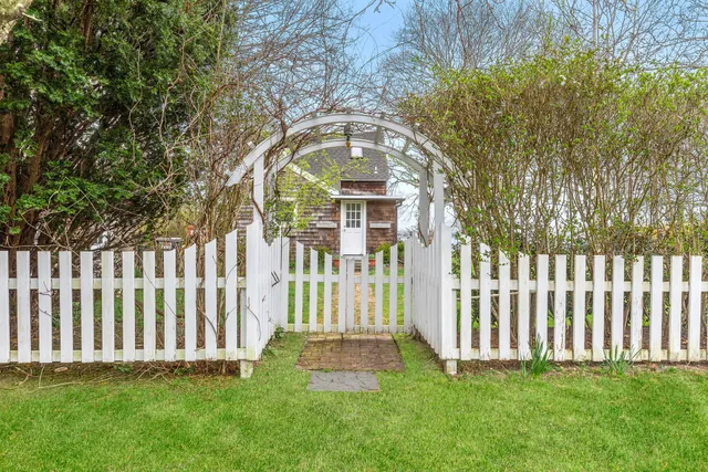 a view of a front of a house with a garden