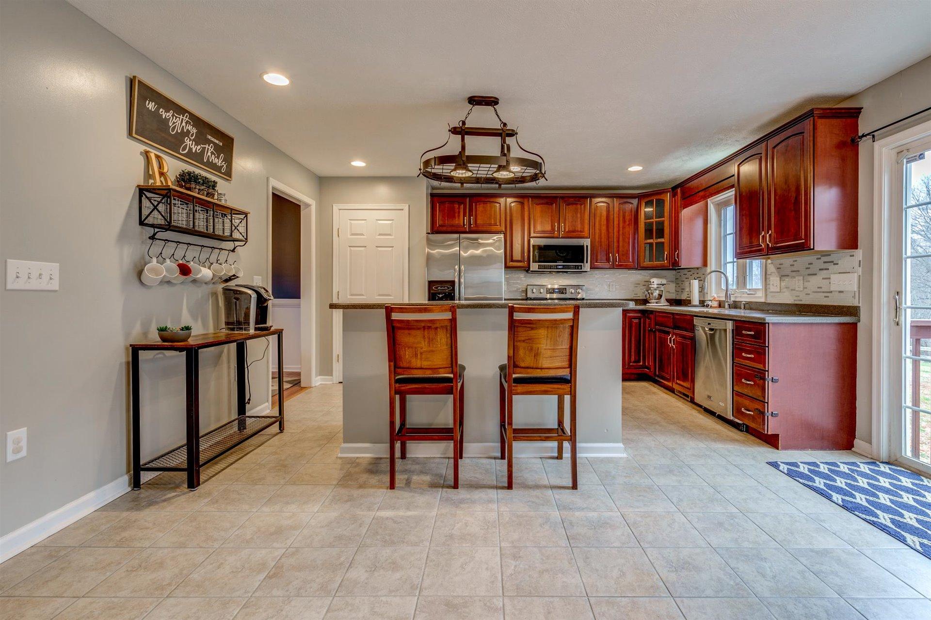 1183 Carroll Road Goodview, VA 24095 - Photo 12 of 61 a kitchen with stainless steel appliances granite countertop a sink and a refrigerator