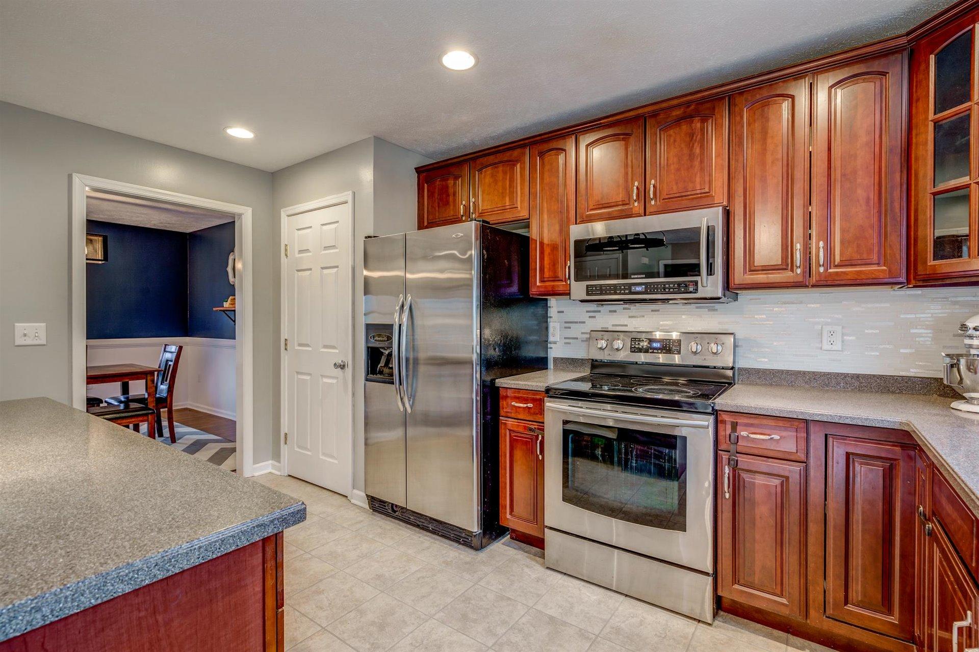 1183 Carroll Road Goodview, VA 24095 - Photo 15 of 61 a kitchen with a stove a microwave and refrigerator