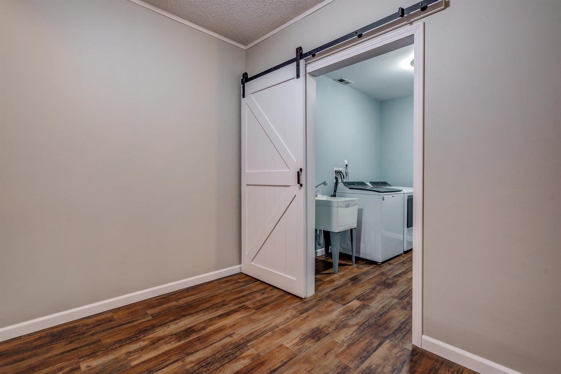 1183 Carroll Road Goodview, VA 24095 - Photo 39 of 61 a view of a room with wooden floor and white walls