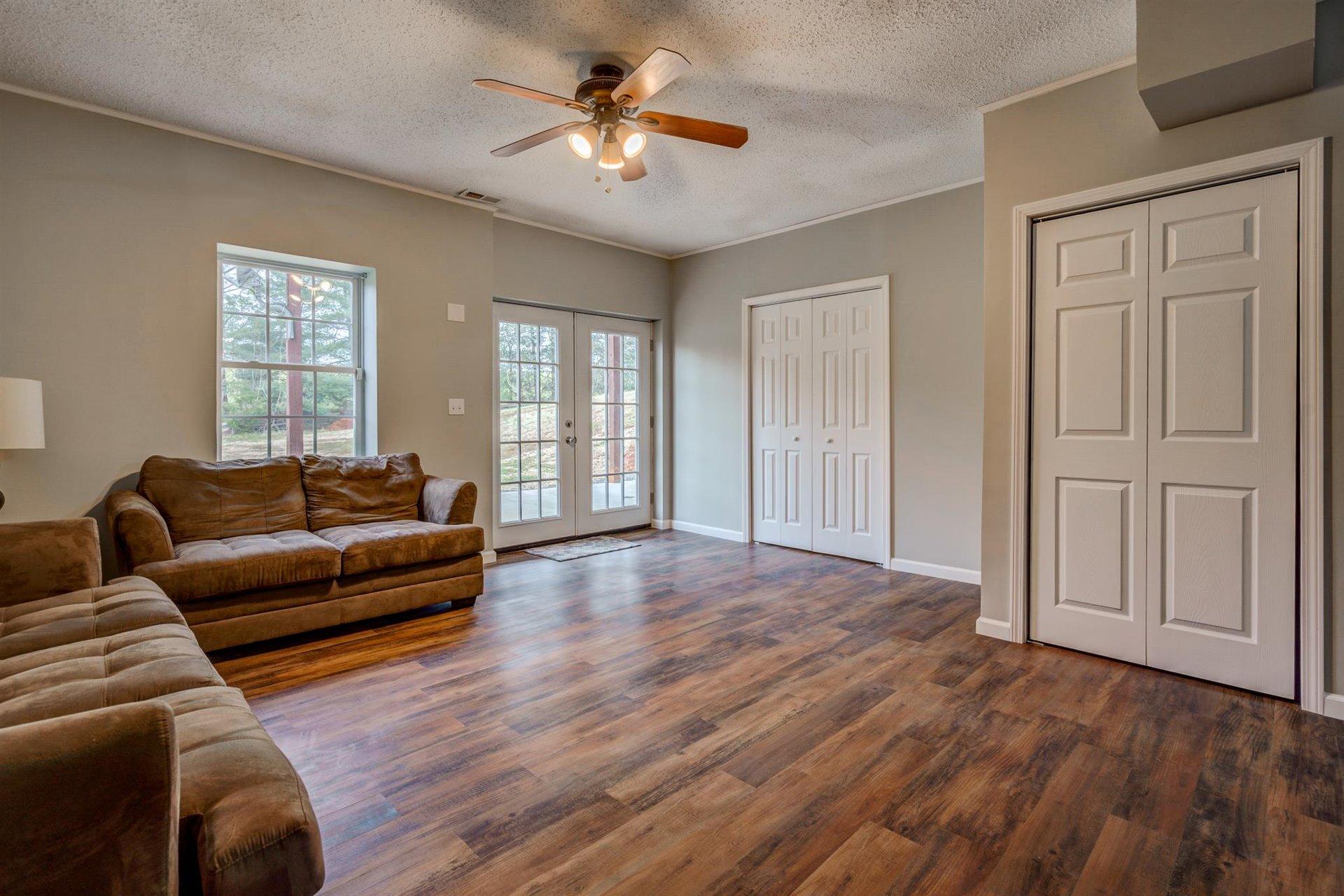 1183 Carroll Road Goodview, VA 24095 - Photo 43 of 61 a living room with furniture and a ceiling fan