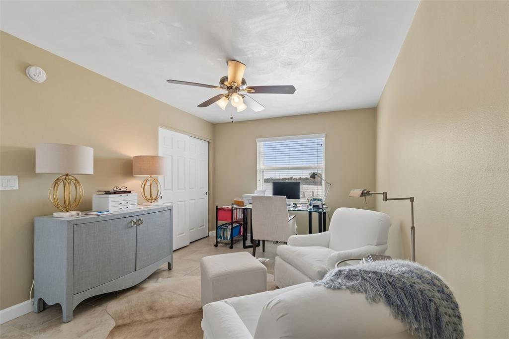 2307 Bay Boulevard Indian Rocks Beach, FL 33785 - Photo 12 of 85 a living room with furniture a chandelier and a window