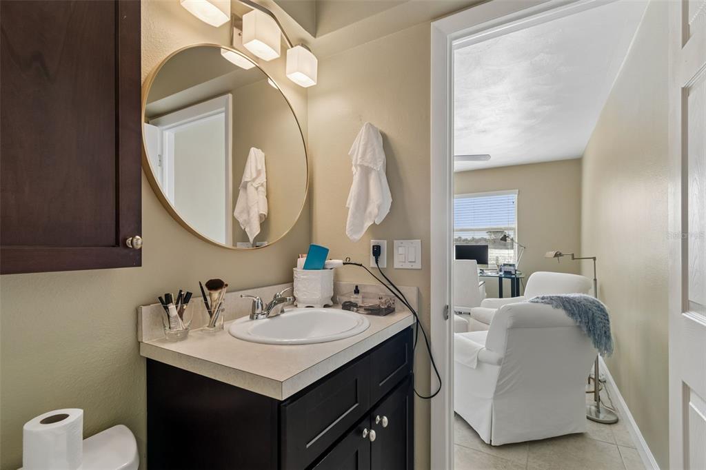 2307 Bay Boulevard Indian Rocks Beach, FL 33785 - Photo 15 of 85 a en suite bathroom with a double vanity sink and a mirror
