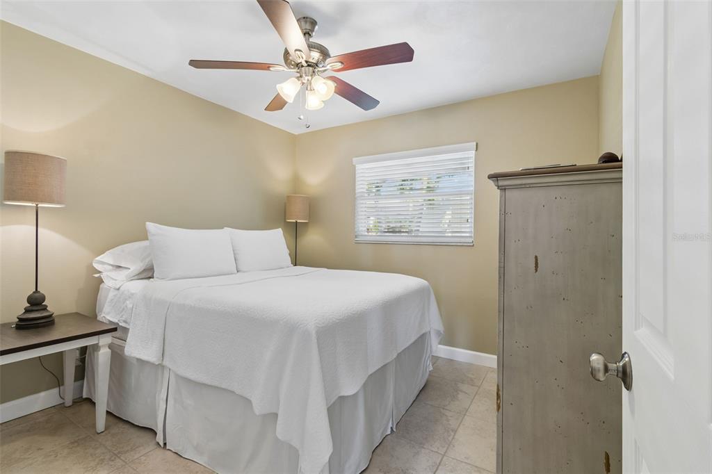 2307 Bay Boulevard Indian Rocks Beach, FL 33785 - Photo 16 of 85 a bedroom with a bed and a chandelier