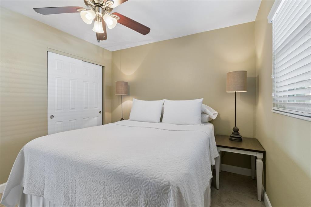 2307 Bay Boulevard Indian Rocks Beach, FL 33785 - Photo 17 of 85 a bedroom with a bed and a chandelier