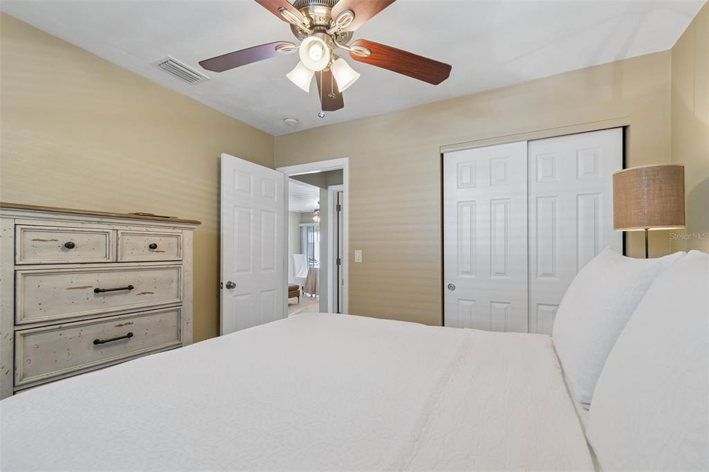 2307 Bay Boulevard Indian Rocks Beach, FL 33785 - Photo 18 of 85 a bedroom with a bed and a chandelier