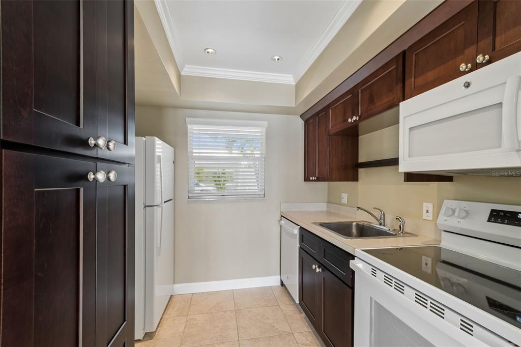 2307 Bay Boulevard Indian Rocks Beach, FL 33785 - Photo 27 of 85 a kitchen with stainless steel appliances granite countertop a sink stove and refrigerator