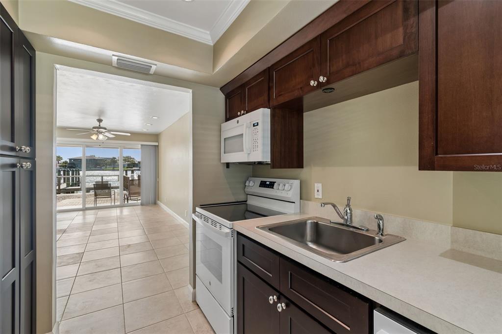 2307 Bay Boulevard Indian Rocks Beach, FL 33785 - Photo 37 of 85 a kitchen with a sink and cabinets
