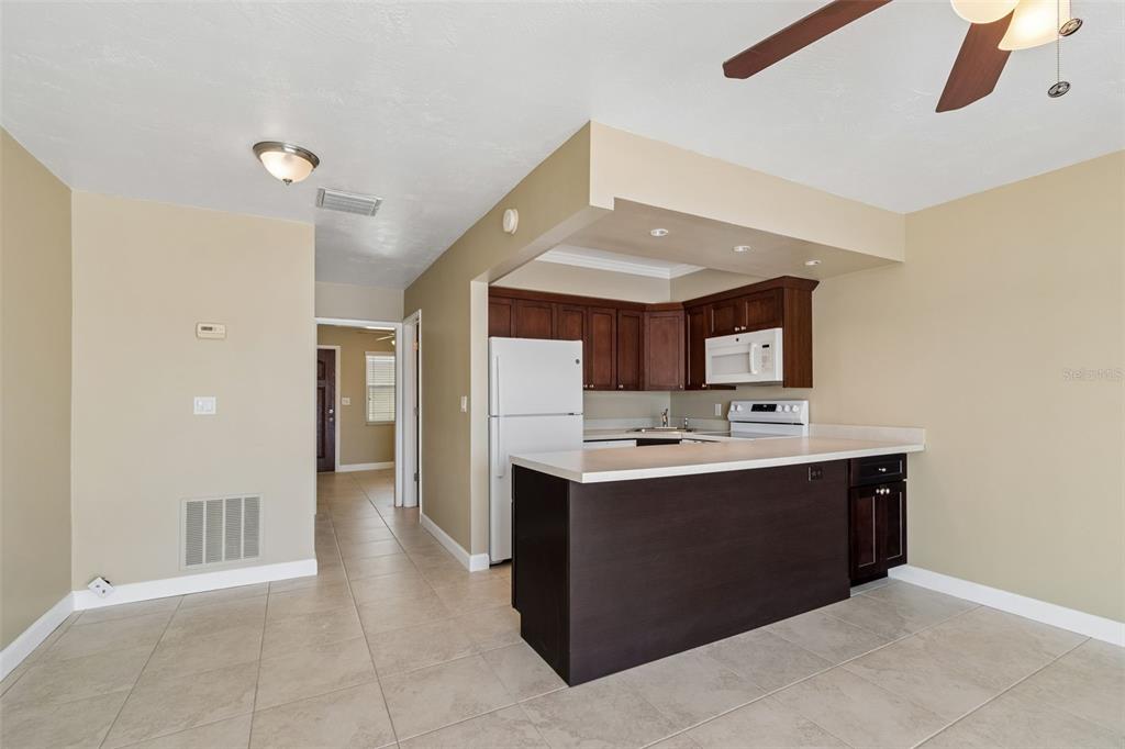 2307 Bay Boulevard Indian Rocks Beach, FL 33785 - Photo 48 of 85 a view with kitchen island a sink a stove and a refrigerator